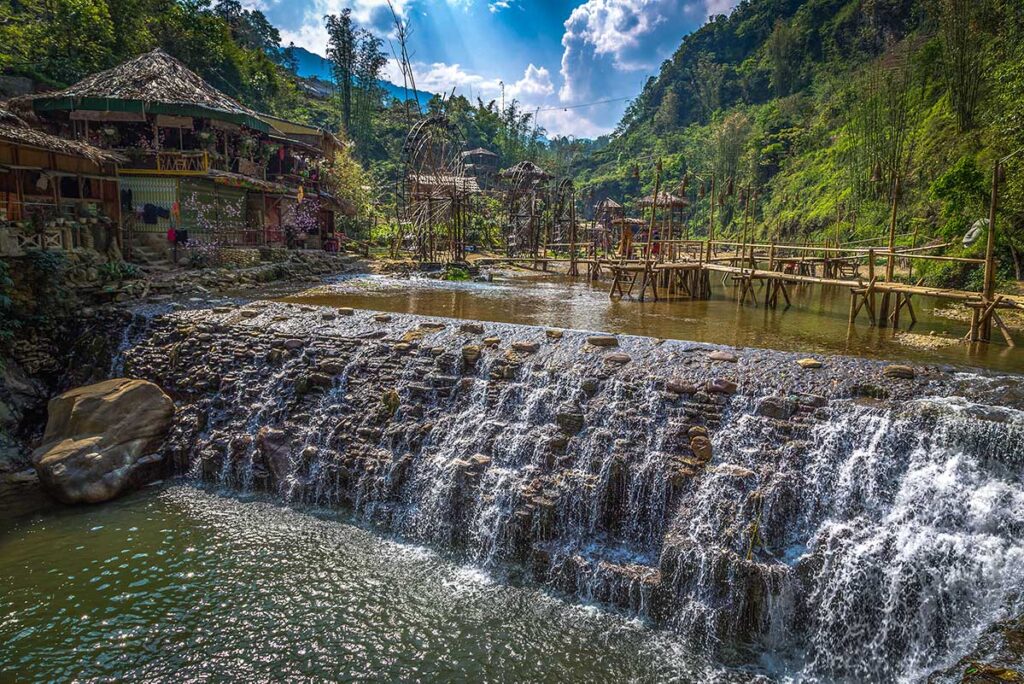 Small waterfall and stream with bamboo water wheels in Cat Cat Village