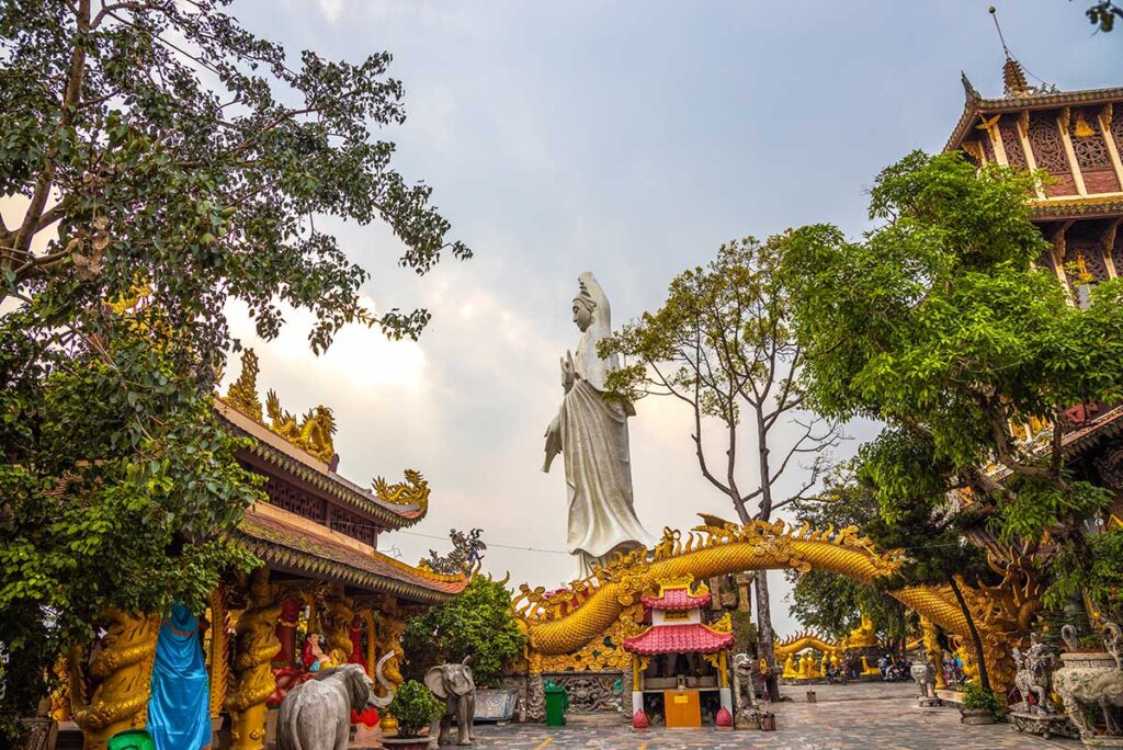 Different temple halls, dragon walls and large statue inside the Chau Thoi Temple