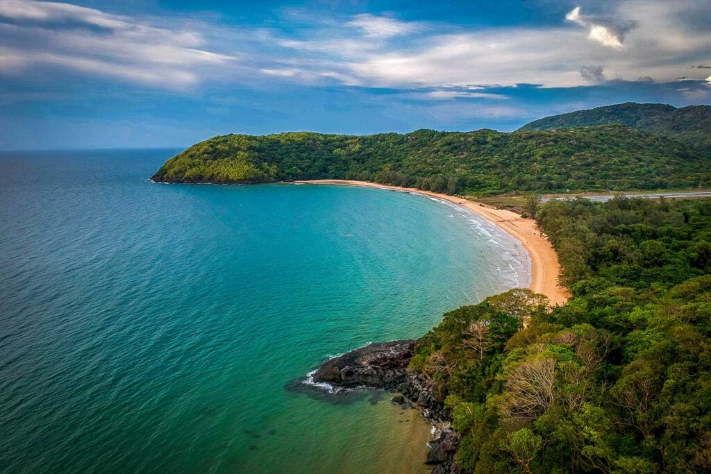 A breathtaking aerial view of Dam Trau Beach, with its crescent-shaped bay and untouched coastline, free of development.