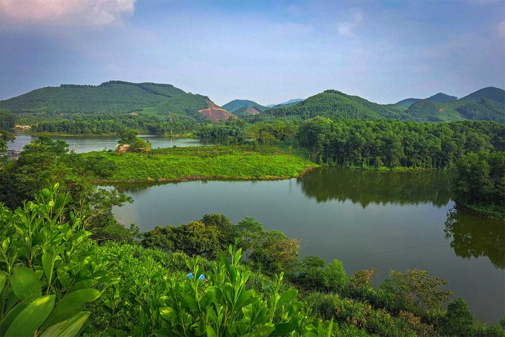 The small Ghenh Che Lake surrounded by forest and countryside in Thai Nguyen Province