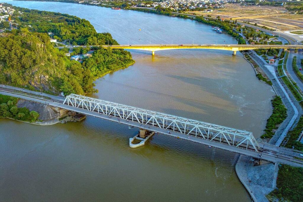 An aerial view over Ham Rong Bridge with over the river with in the background a smaller modern bridge