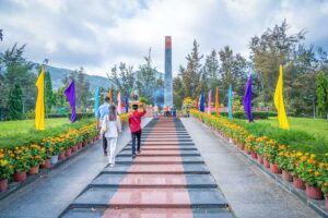 Vietnamese visitors walk towards a monument and altar inside Hang Duong Cemetery, a memorial site for Con Dao’s historical past.