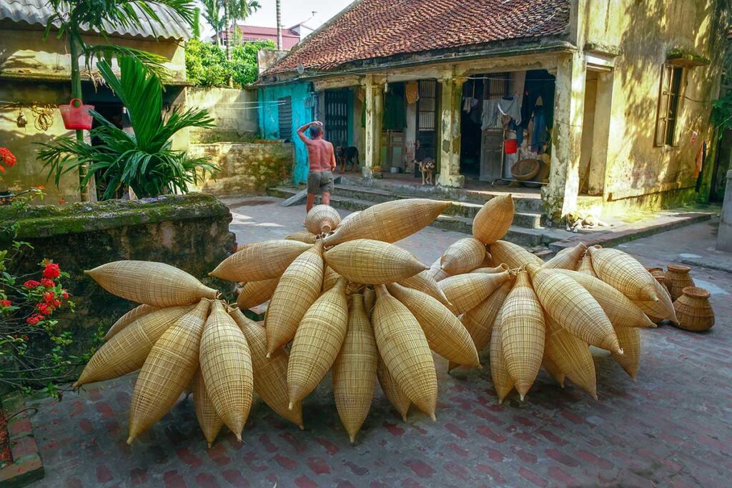 Bamboo fish traps on the street in front of an old house in Hun Yen