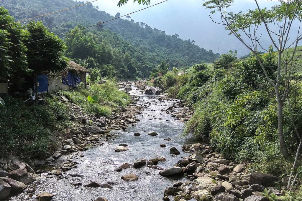 The Kem Stream with rocks and forest in La Bang