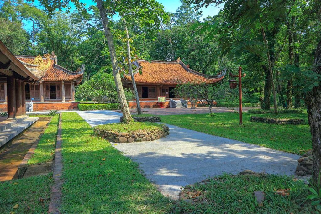 Garden area with trees surrounding old structures of Lam Kinh Palace in Thanh Hoa