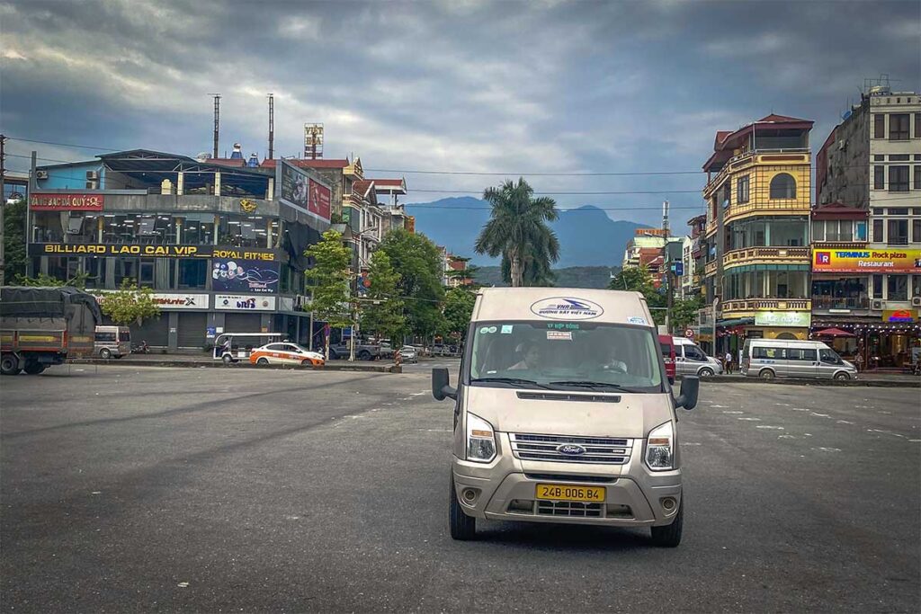 A shuttle bus departing from Lao Cai and on its way to Sapa