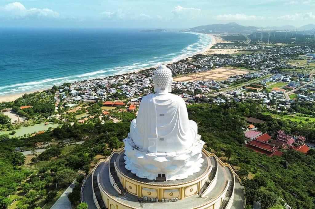 Aerial view of Ong Nui Temple’s giant seated Buddha overlooking Quy Nhon’s coastline and Thi Nai Lagoon.