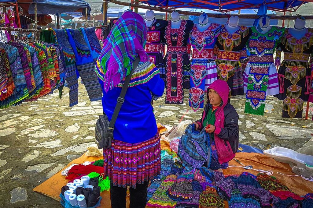 Ethnic minority woman selling clothes at the Lung Phin Market