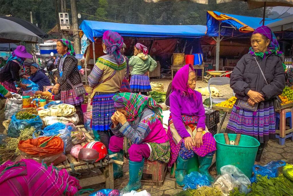Ethnic minority woman selling local products on Lung Phin Market in Bac Ha