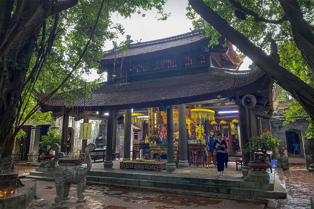 A shrine with altar surrounded by trees at Mau Temple in Hun Yen