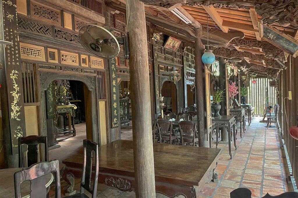 Traditional wooden dining area with antique tables and chairs inside Ong Kiet’s Ancient House, reflecting the elegant lifestyle of southern Vietnam’s elite families.