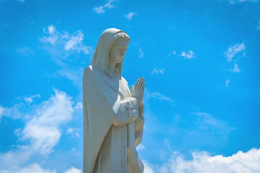 A detailed close-up of the top section of the Our Lady of Nui Cui statue, focusing on the face of the Virgin Mary.