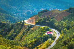 A breathtaking aerial perspective of Pha Din Pass, showcasing its curving roads through the mountains.