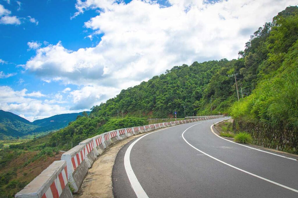 A sharp turn along the famous Pha Din Pass, highlighting the steep mountain terrain and winding roads.