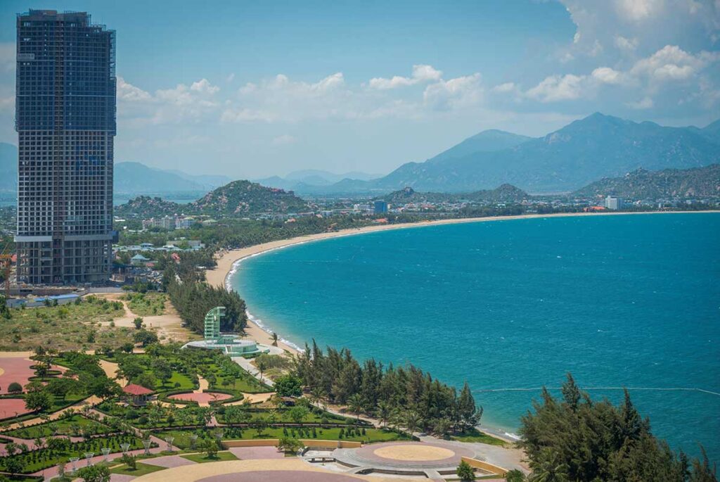 Panoramic view of Phan Rang city with its long sandy bay, high-rise building, and surrounding mountains