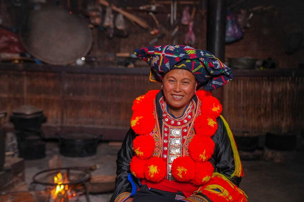 Red Dao ethnic woman inside a traditional house in Tuyen Quang