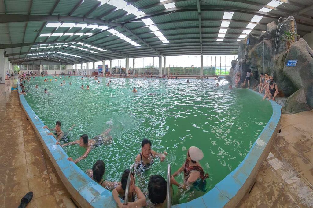 A swimming pool with locals swimming in Thanh Thuy