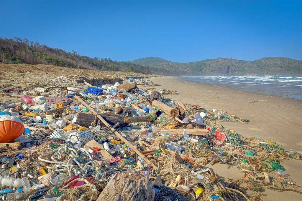 Polluted section of Dong Beach in Con Dao with plastic waste and debris washed ashore, highlighting environmental challenges on some beaches of the island.