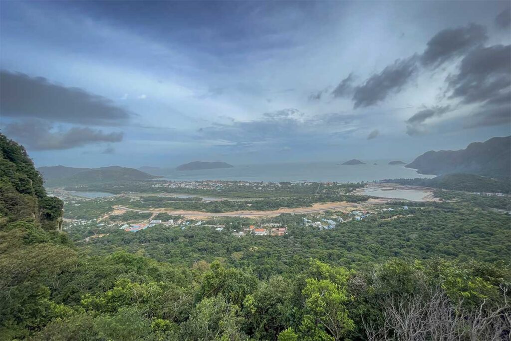 Panoramic view over Con Son Town, coastline, and surrounding islands from So Ray Viewpoint in Con Dao National Park under cloudy skies