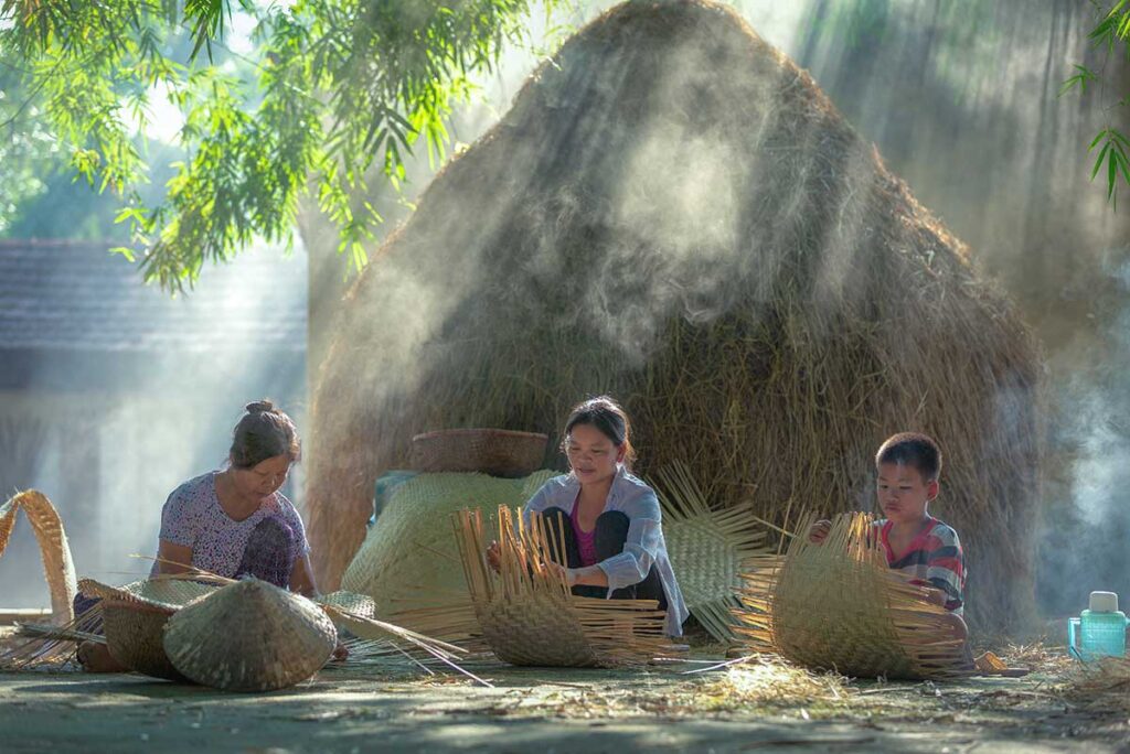 Local woman sitting on the floor at a village in Vinh Phuc