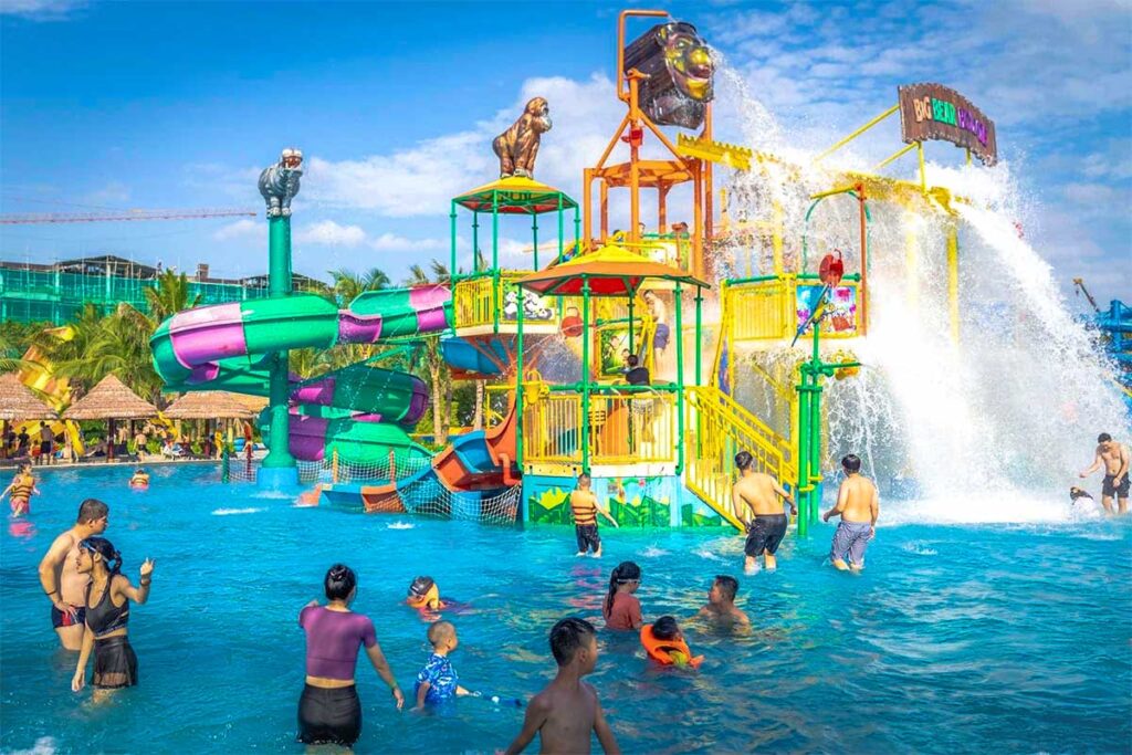 Kids and adults playing in a pool with slides of VinWonders waterPark in Hung Yen