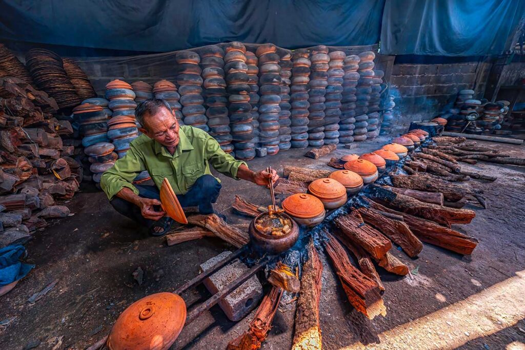 Old man Braised fish Vu Dai Village in Northern Vietnam. This is Traditional food Tet holiday in Vietnam. Hoa Hau commune, Ha Nam province, Vietnam near Vu Dai village.