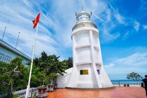 The small white lighthouse of Vung Tau with a Vietnamese flag
