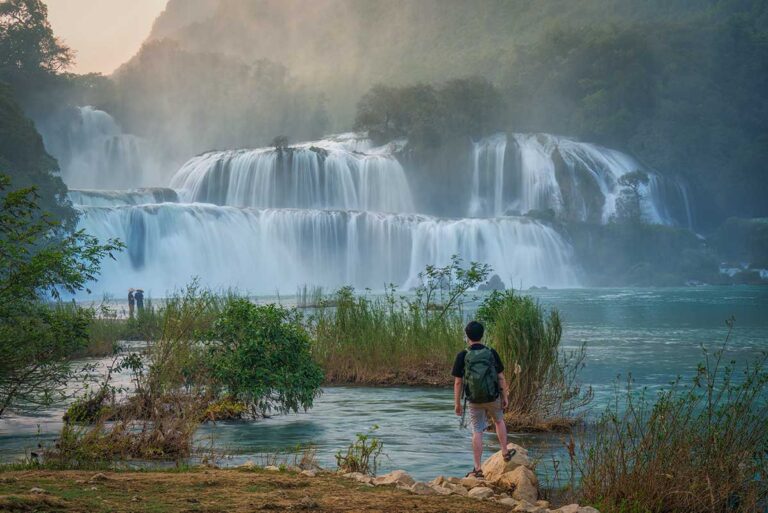 Traveler standing near Ban Gioc Waterfall in Cao Bang, one of the most scenic places to visit in northern Vietnam