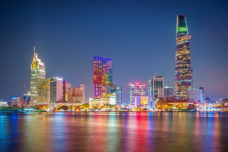 Ho Chi Minh City skyline at night along the Saigon River, highlighting the modern side of Vietnam travel in the south