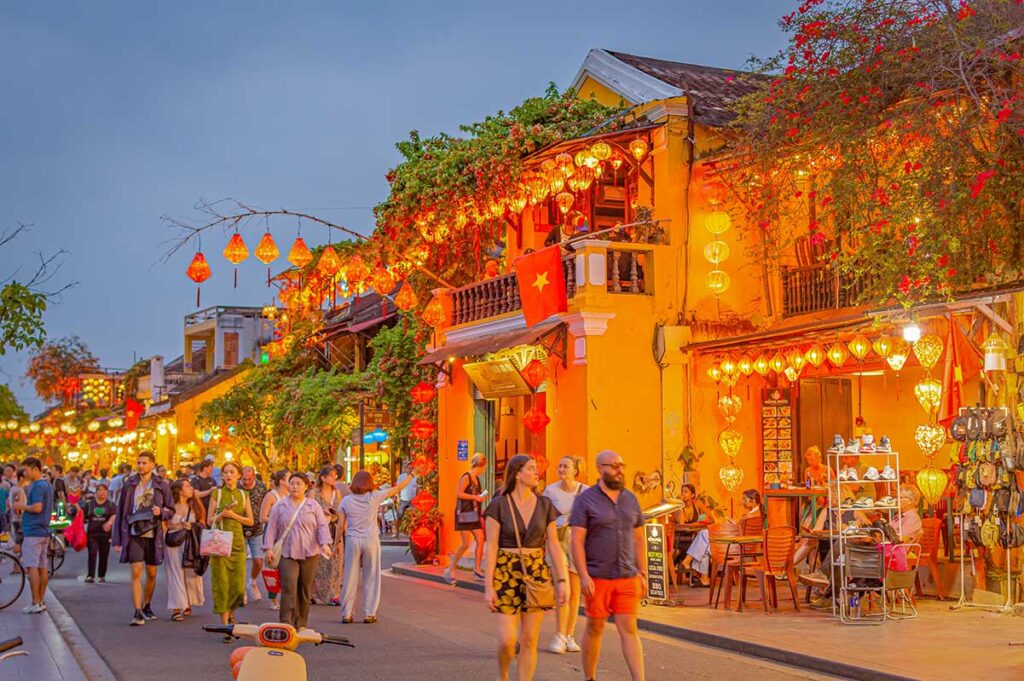 Evening stroll through Hoi An Ancient Town in April, with yellow lantern-lit streets and pleasant warm temperatures that attract both locals and travelers.