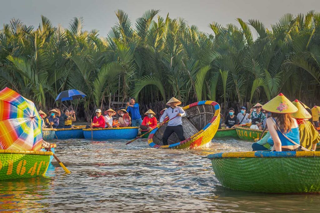 Tourists enjoying basket boat rides in Hoi An’s Coconut Village in June, when sunny weather and high temperatures make early morning tours the most comfortable time to explore.
