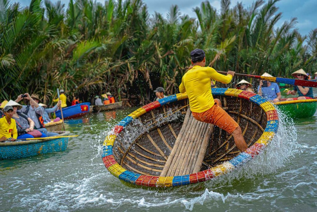 Basket boat spinning performance in Hoi An’s Cam Thanh Coconut Village during March, a month known for pleasant temperatures and outdoor river activities.
