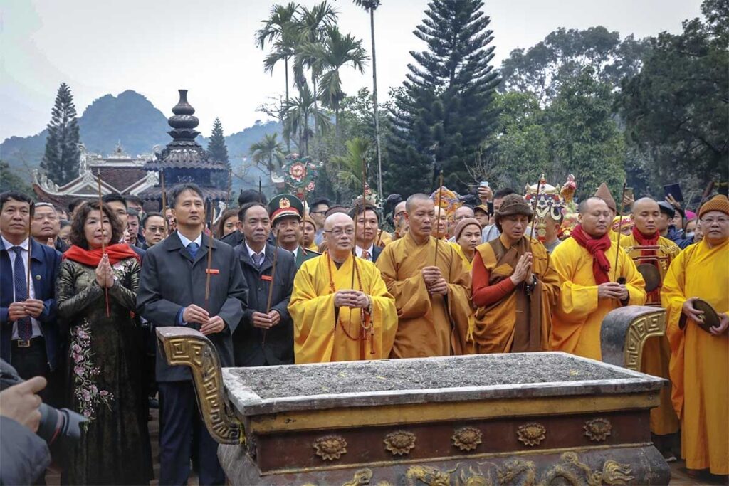Monks, pilgrims and officials from the Vietnamese government are praying at a temple inside the Perfume Pagoda during the Perfume Pagoda Festival 