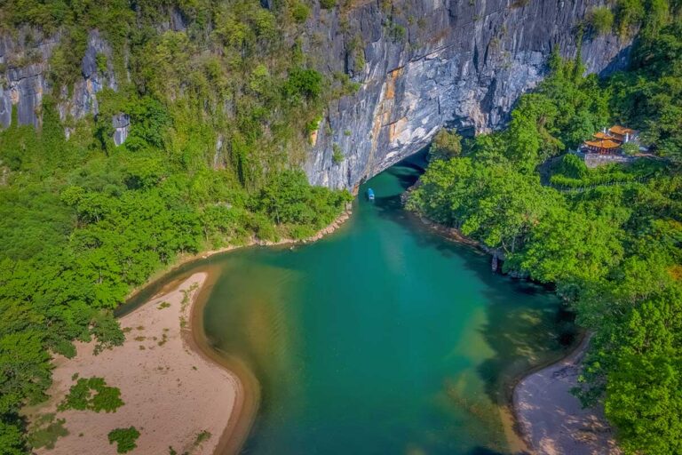 Aerial view of river and limestone cliffs in Phong Nha, home to some of the largest caves in Vietnam