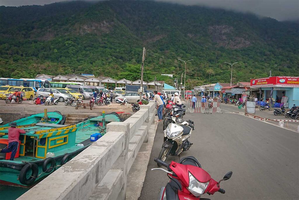 Taxi, motorbikes and local transport waiting at Ben Dam Port in Con Dao for arriving ferry passengers