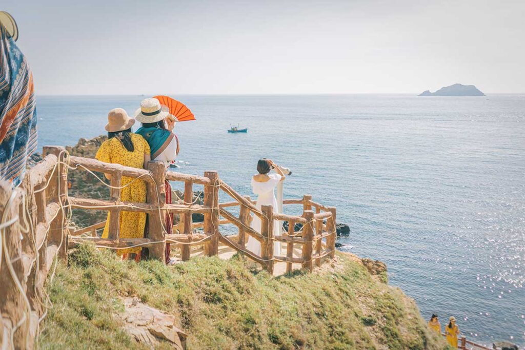 Travelers enjoying the panoramic viewpoint at Eo Gió, Quy Nhon, facing the South China Sea