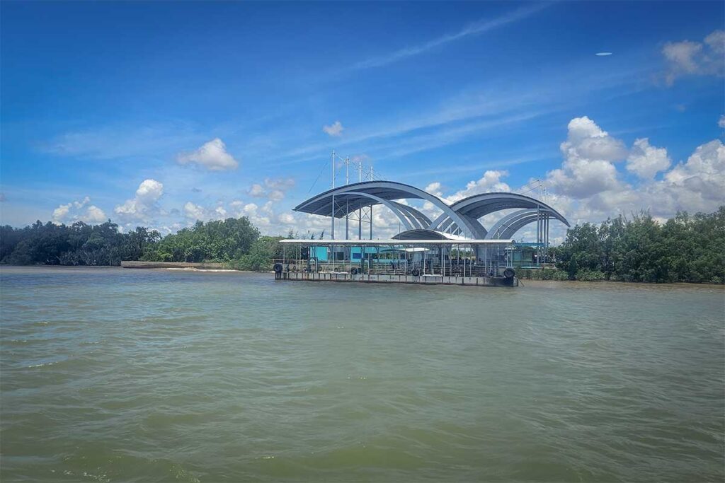 Modern ferry terminal building at Tran De in the Mekong Delta surrounded by river water and tropical landscape