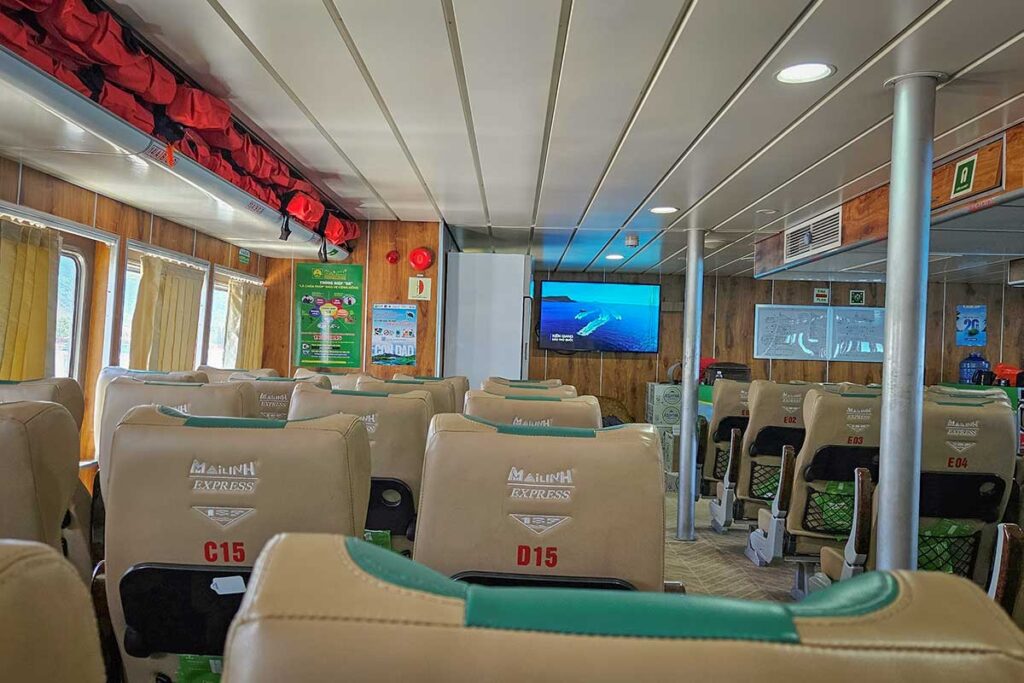 Interior of ferry to Con Dao with comfortable seating, air-conditioned cabin and passengers onboard during the crossing