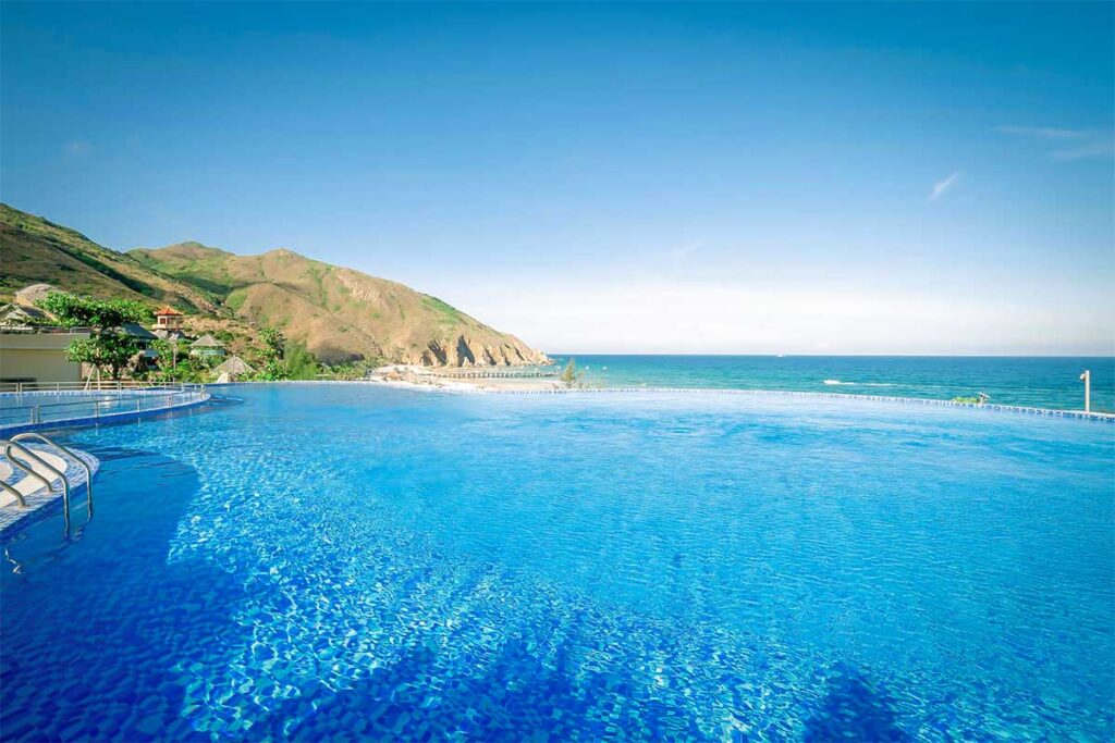 nfinity pool at Ky Co Peninsula Quy Nhon Resort – Large blue pool overlooking the sea and mountains near Ky Co Beach.