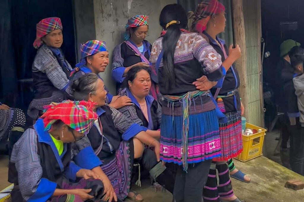 Mu Cang Chai cultural tour with Hmong women gathered in traditional clothing at a local village event