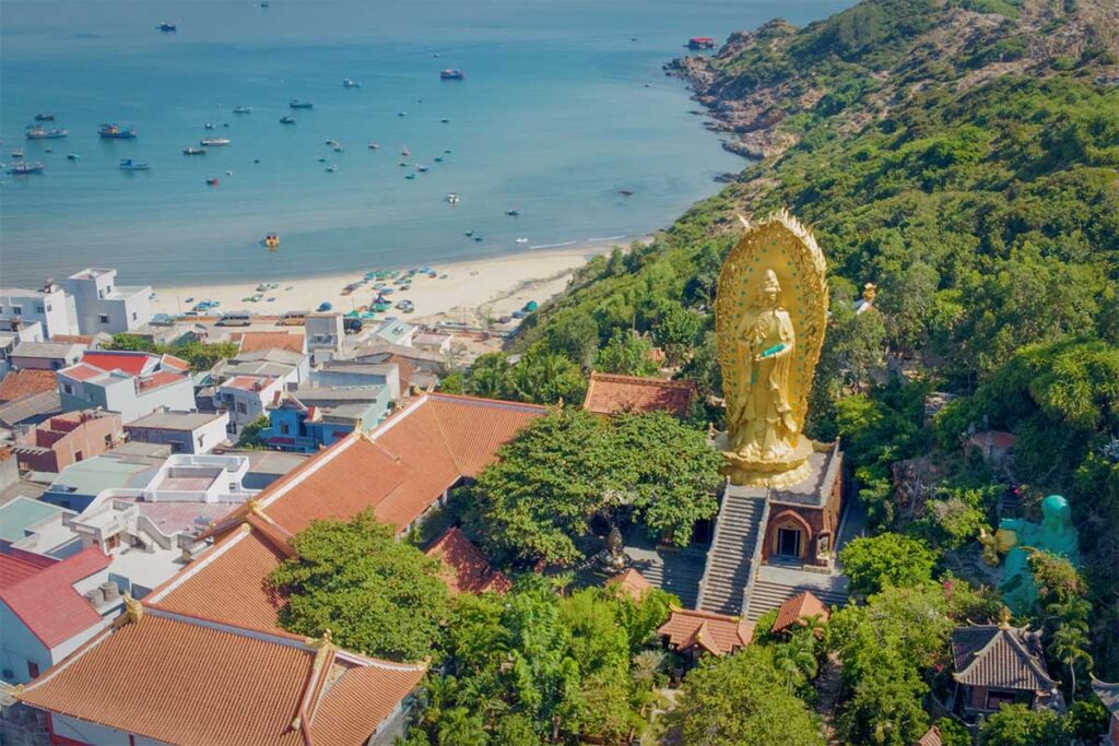 Ngoc Hoa Monastery with golden Guanyin statue overlooking Nhon Ly beach in Quy Nhon, near Eo Gió