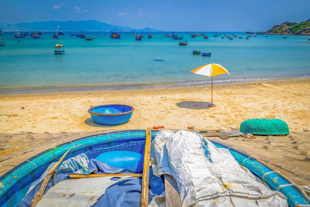 Nhơn Lý Beach with round fishing boats and umbrellas on the sand, near Eo Gió Quy Nhon