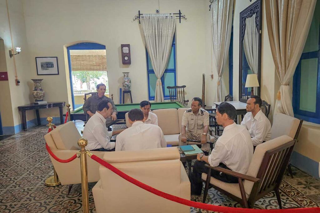 Interior room of the Palace of the Island Governor on Con Dao with mannequins recreating a meeting between colonial officials managing the prison system.