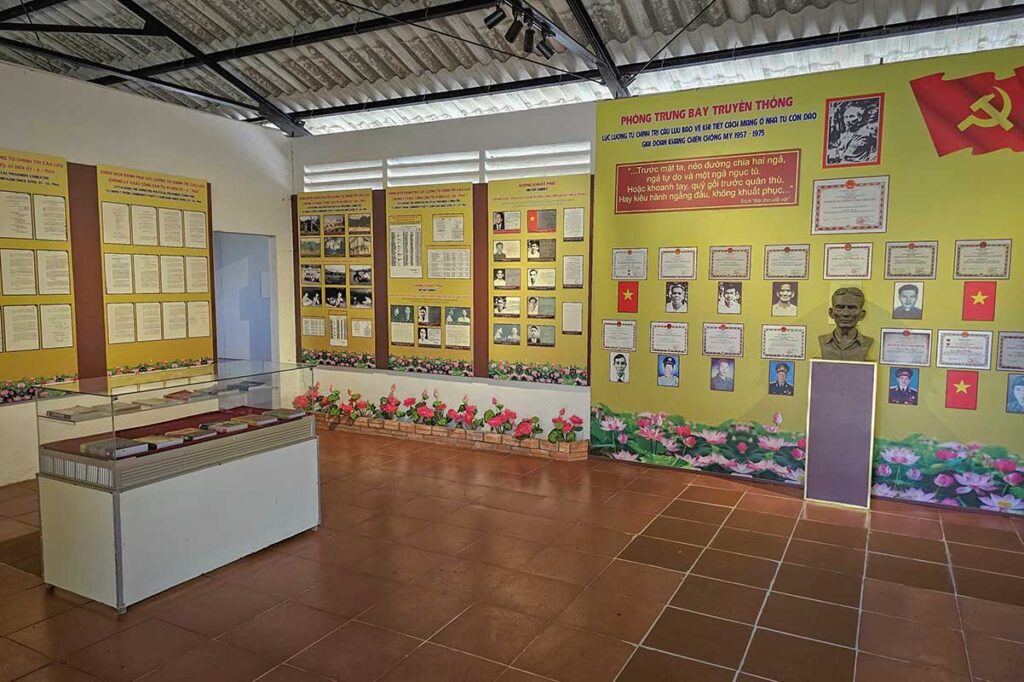 Exhibition room at Phu An Prison on Con Dao displaying photos, documents, and portraits of former prisoners from the Con Dao prison system.