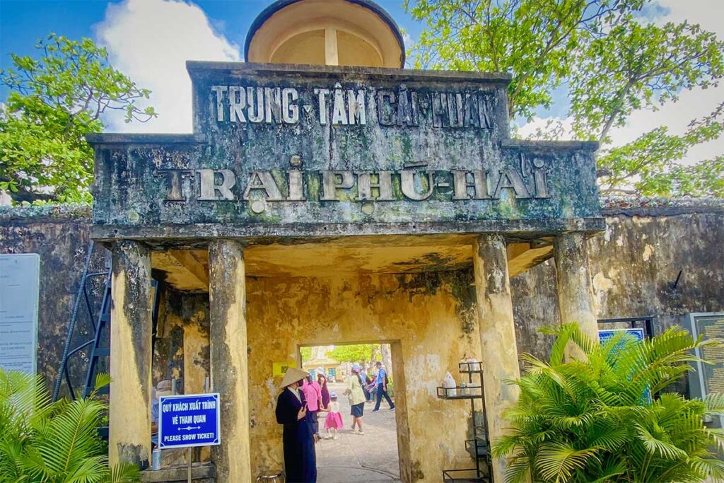 Entrance gate of Phu Hai Prison on Con Dao with weathered colonial structure and signage, marking one of the oldest and most important sites in the Con Dao prison complex.