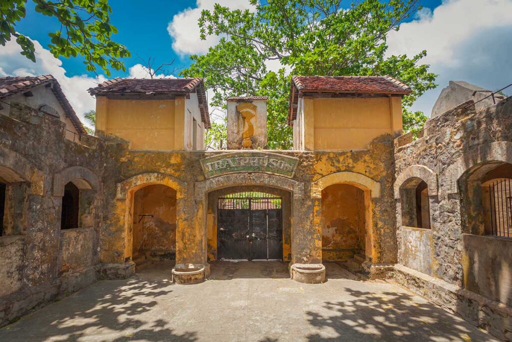 Entrance gate of Phu Son Prison on Con Dao with weathered colonial architecture, marking one of the earliest prison camps built during French rule.