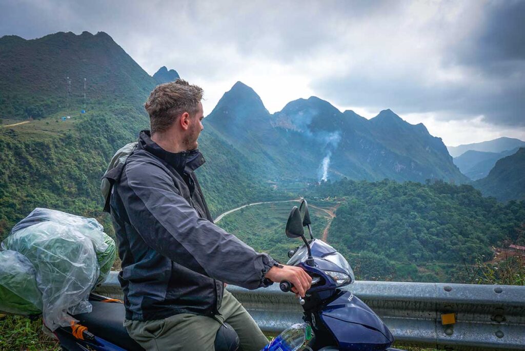 A foreign traveller driving through mountains along the Cao Bang Loop