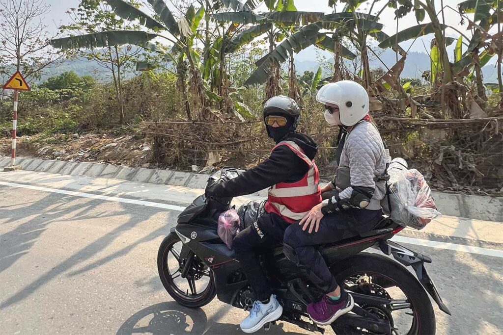 Easy Rider motorbike tour in Ha Giang with tourists riding through mountain scenery