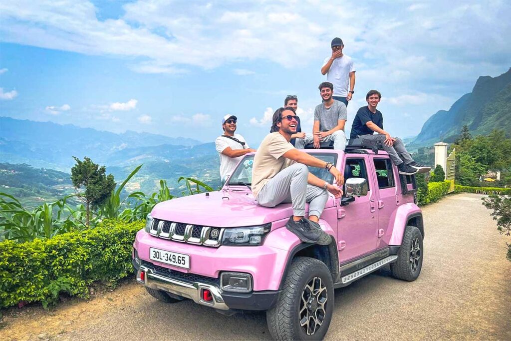 Group of friends posing on top of a jeep along the Ha Giang Loop route