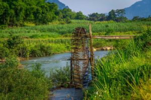 Traditional bamboo waterwheel along a river in Pu Luong Nature Reserve, a highlight of a private day tour from Mai Chau.